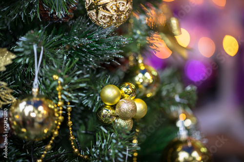 Decorations on christmas tree at night with bokeh on background  soft focus