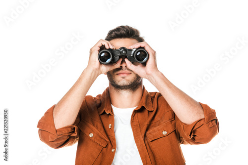 handsome young man looking at camera with binoculars isolated on white