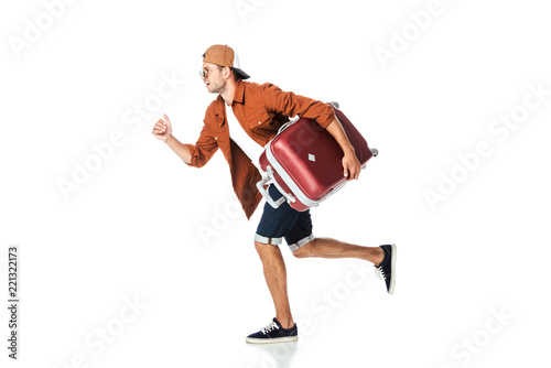 side view of handsome man running with luggage isolated on white © LIGHTFIELD STUDIOS