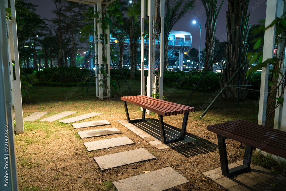 Wooden bench in the park at night