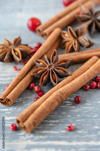 Fototapeta Naklejka Na Ścianę i Meble -  anise seeds, cinnamon sticks and pink pepper - spice  for cooking meats, cakes or mulled wine on wooden table, selective focus and copyspace, Christmas 2019, new year 2019
