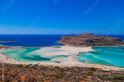 Amazing view of Balos Lagoon with magical turquoise waters, lagoons, tropical beaches of pure white sand and Gramvousa island on Crete, Greece