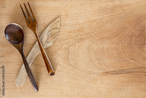 Wooden spoon knife and fork on wooden background