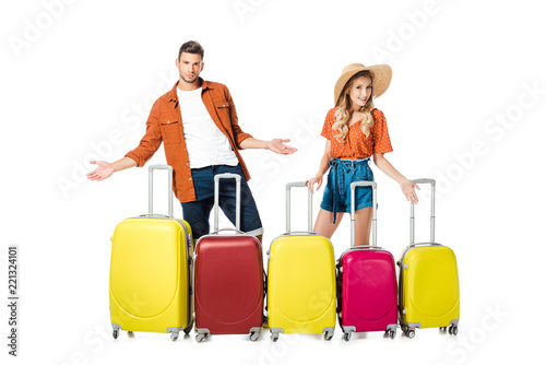 newlywed couple with arranged suitcases around isolated on white © LIGHTFIELD STUDIOS
