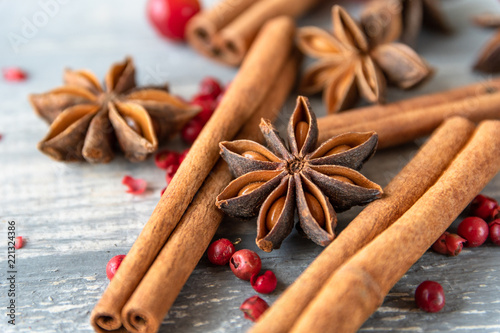 Fototapeta Naklejka Na Ścianę i Meble -  anise seeds, cinnamon sticks and pink pepper - spice  for cooking meats, cakes or mulled wine on wooden table, selective focus and copyspace, Christmas 2019, new year 2019