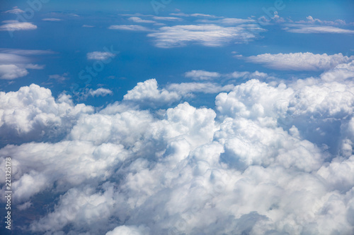 Blue sky, white clouds cover the earth background. Aerial photo from airplane's window. © viperagp