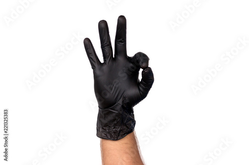 Male hand in black glove shows gesture ok. Isolate on white background. The concept of a successful cleaning firm