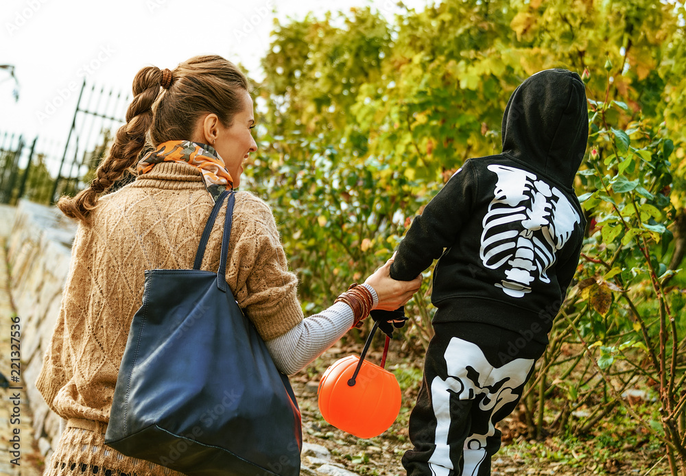 mother and daughter with Halloween pumpkin Jack O’Lantern basket playing