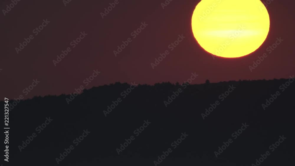 Sunrise behind mountain range, fast motion, long shot Sunrise behind mountain range, fast motion, long shot