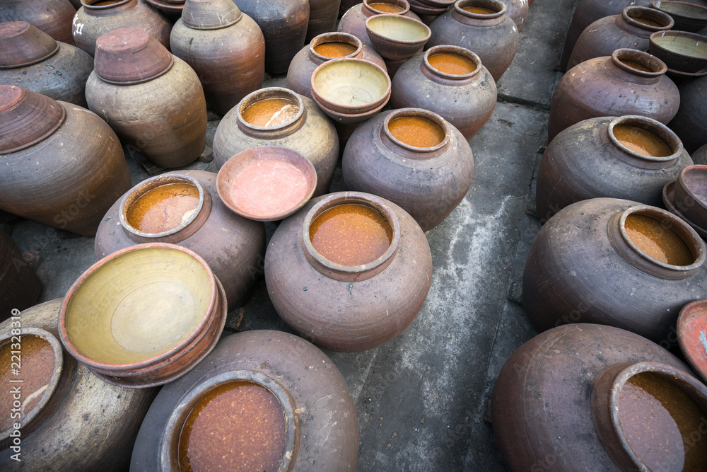 Jars of processing soybean jam made by traditional outdoor way under natural sunlight Jars of processing soybean jam made by traditional outdoor way under natural sunlight
