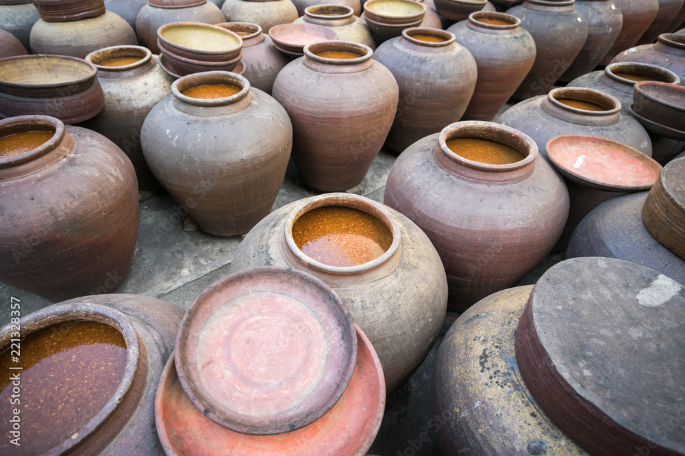 Jars of processing soybean jam made by traditional outdoor way under natural sunlight Jars of processing soybean jam made by traditional outdoor way under natural sunlight