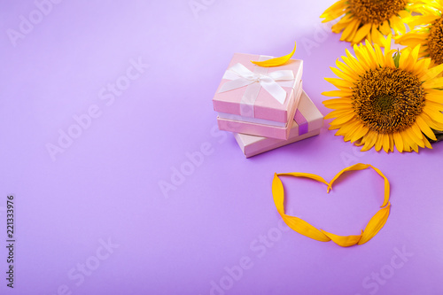 Two gift boxes with sunflowers. Presents with jewellery. Space © maryviolet