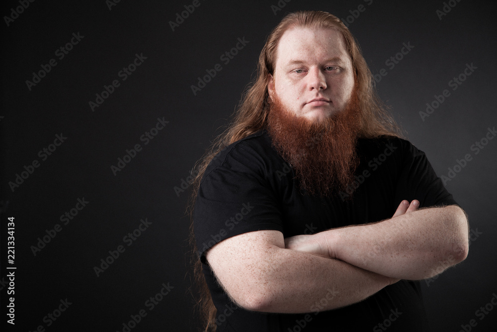  Portrait of a handsome man. Big serious guy on a dark background.
