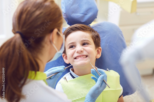 Картината върху платно A child with a dentist in a dental office