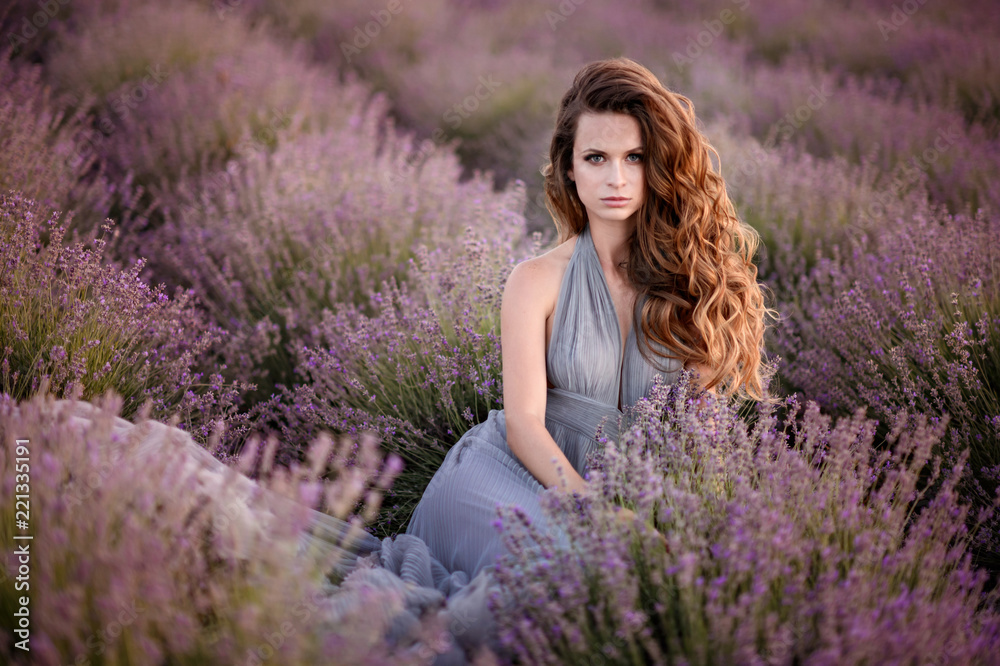 Woman in amazing dress walk on the lavender field. Woman in amazing dress walk on the lavender field.