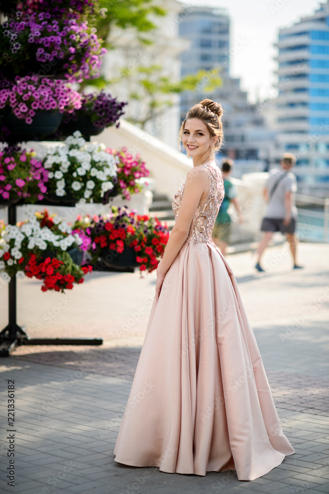 Beautiful girl in wedding dress outdoor. Happy girl in prom.