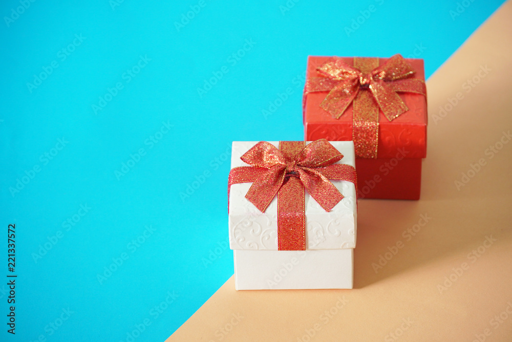 Fototapeta premium Red and white gift boxes on blur and brown background, picture have space for idea.