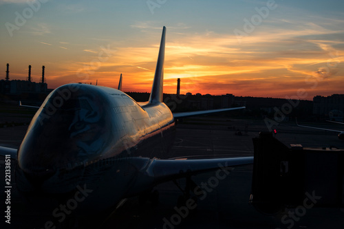 sunset in the city airport with airplane on front photo