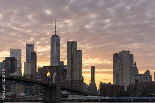 View of Manhattan skyline and Brooklyn bridge at sunset