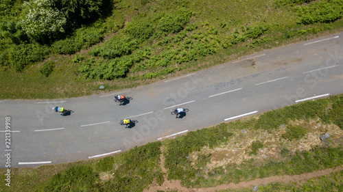Aerial view of cyclists riding along a road