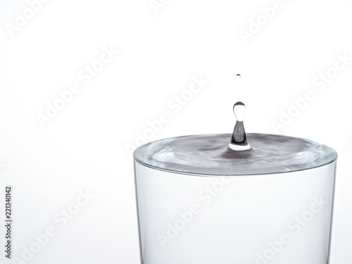 Foto Drop of water, about to make the glass overflow and run over