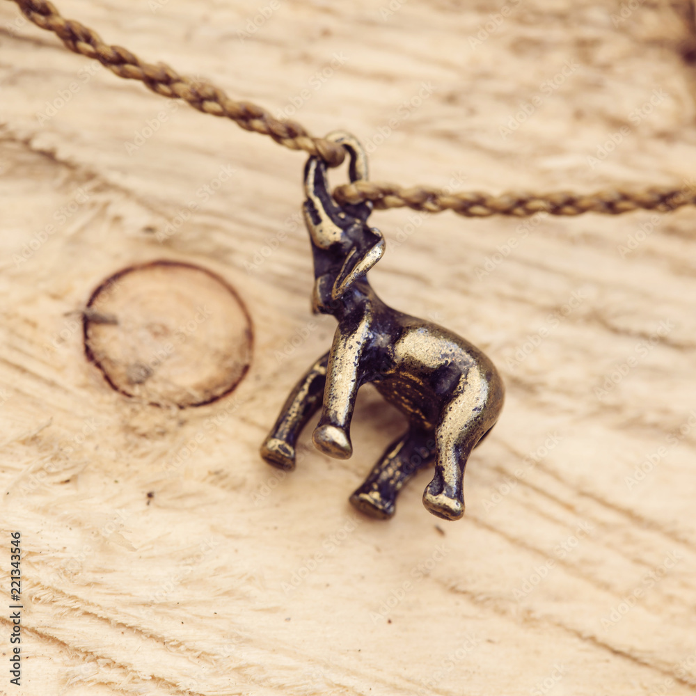 Tiny fashionable female bracelet on wooden background Tiny fashionable female bracelet on wooden background