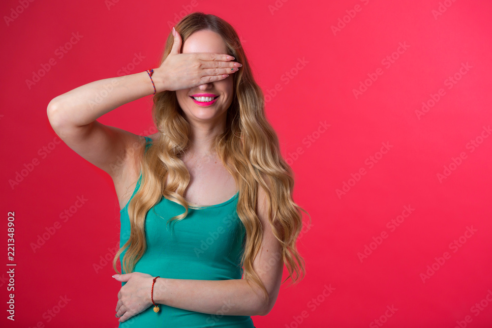 beautiful young girl with her hair on a red background with her eyes closed beautiful young girl with her hair on a red background with her eyes closed