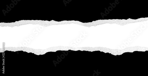 Gap ripped in black paper on white background. Copy space photo