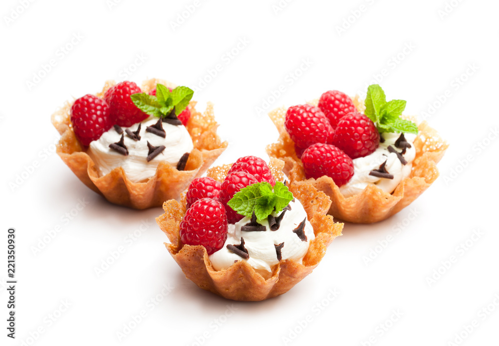 Brandy snap baskets with ice cream and berries isolated on white Brandy snap baskets with ice cream and berries isolated on white