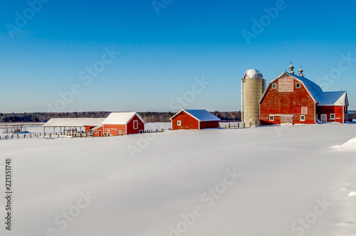 Farm Outbuilding Descend a Snowy Hill in Minnesota