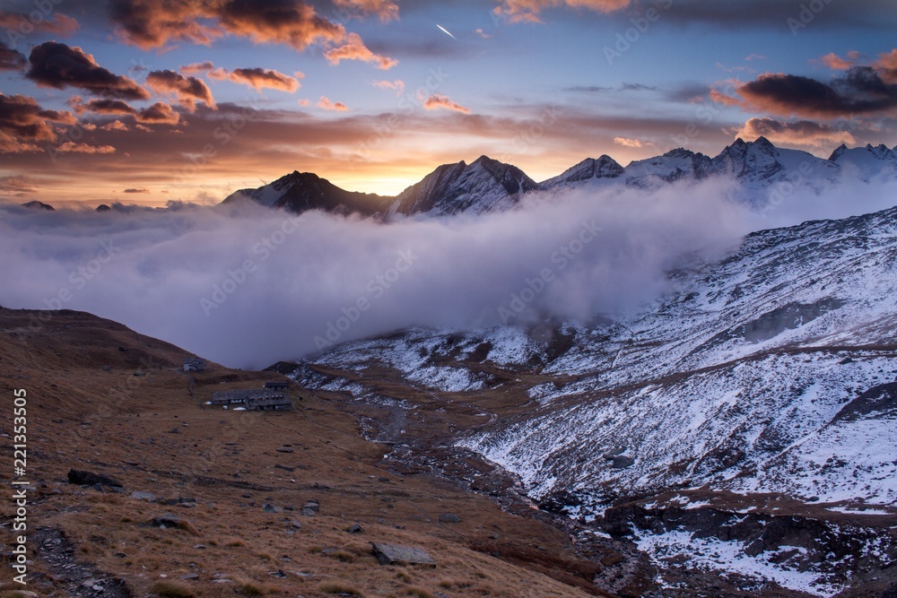 Great view of the foggy valley in Gran Paradiso National Park,  Alps, Italy,  dramatic scene, beautiful world. colourful autumn morning,scenic view with cloudy sky, majestic dawn in mountain landscape