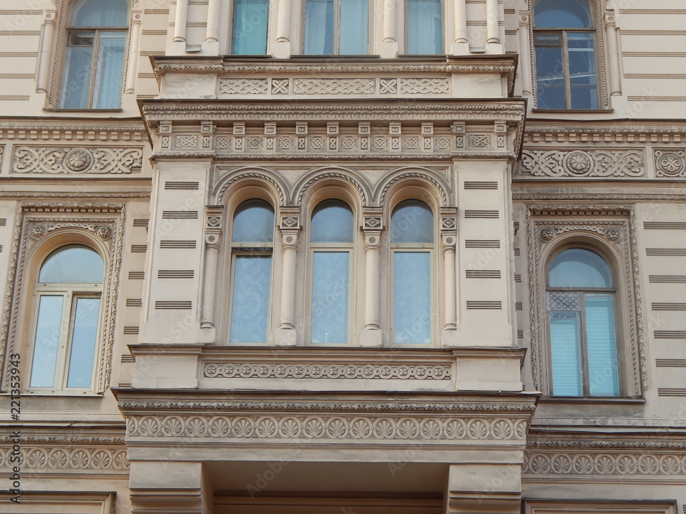 Fragment of the facade of the beautiful old house Muruzi in St. Petersburg, decorated with arches and oriental ornament