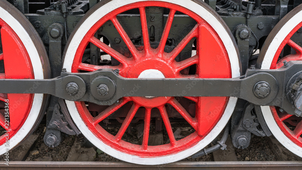 large red-white steam locomotive wheels.