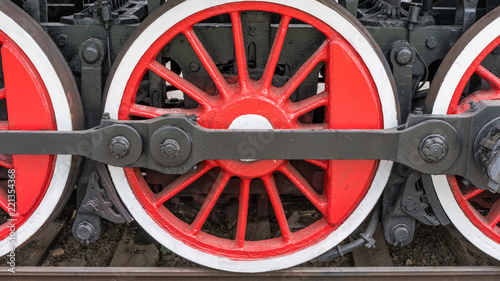 large red-white steam locomotive wheels.