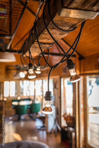 Close up of lightening chandeliers in wooden log cabin © poplasen