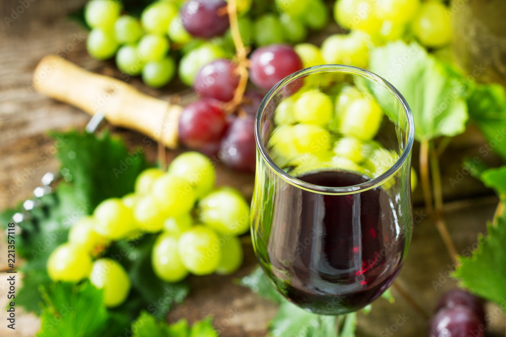 Wine background. Red wine in glasses close-up, bottle, grapes on vintage background, wine concept.