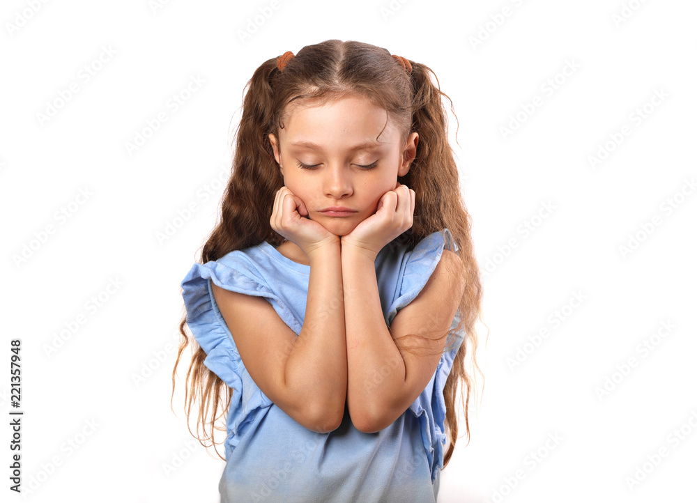 Beautiful girl with sad closed eyes on the face and pouted lips. Closeup portarit of cute kid with long hair on white background Beautiful girl with sad closed eyes on the face and pouted lips. Closeup portarit of cute kid with long hair on white background