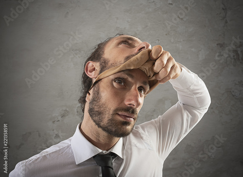 Schilderij op canvas Businessman that removes the mask. Concept of falsity