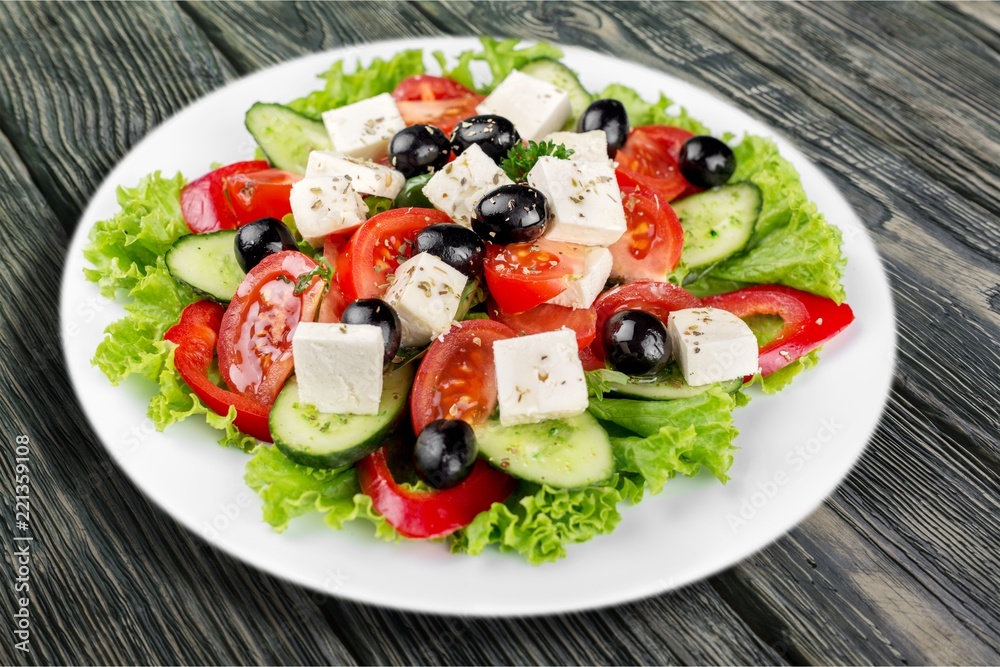 Greek salad with fresh vegetables on background Greek salad with fresh vegetables on background