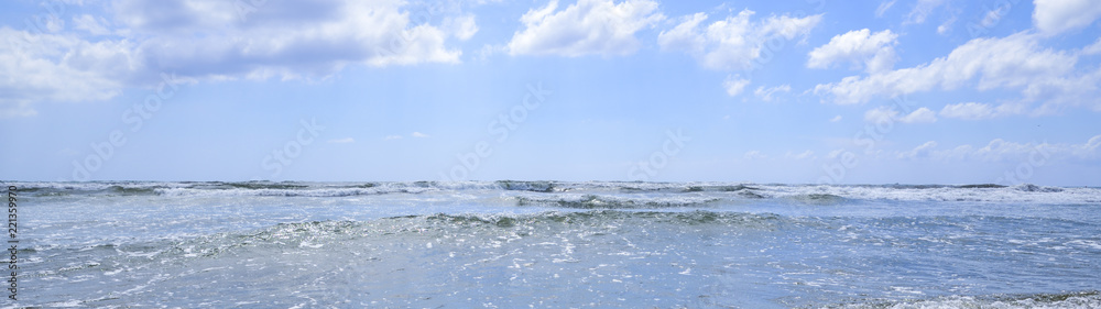 sea waves break on the sunny beach