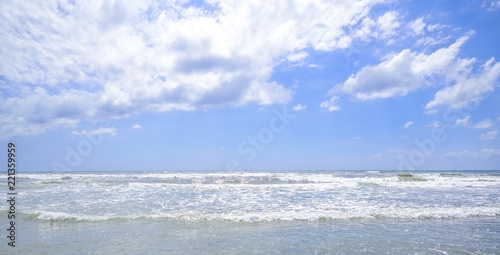 sea waves break on the sunny beach