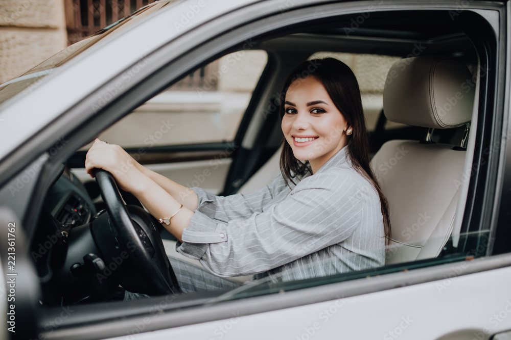 Beautiful Smiling woman driving car. attractive girl sitting in automobile