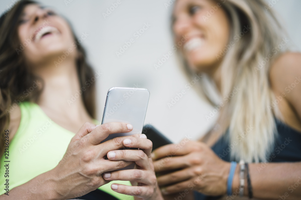 Two girls interacting with the smartphone Two girls interacting with the smartphone