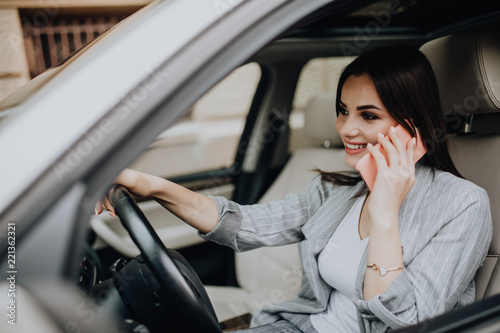 Portrait of woman driver talking her mobile phone while driving car. © F8  \ Suport Ukraine