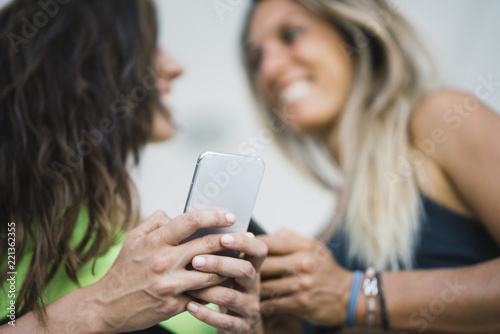Two girls interacting with the smartphone