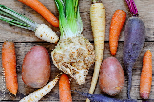 Mix of fresh farmers market vegetable from above on the old wooden board. Healthy eating background. Top view  photo