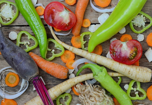 Mix of fresh farmers market vegetable from above on the old wooden board. Healthy eating background. Top view  photo