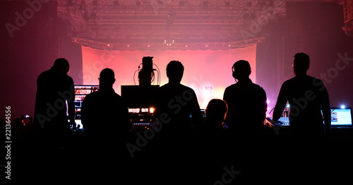 Sound and lighting technicians and the crowd in a concert