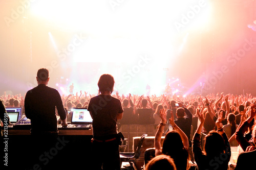 Sound and lighting technicians and the crowd in a concert