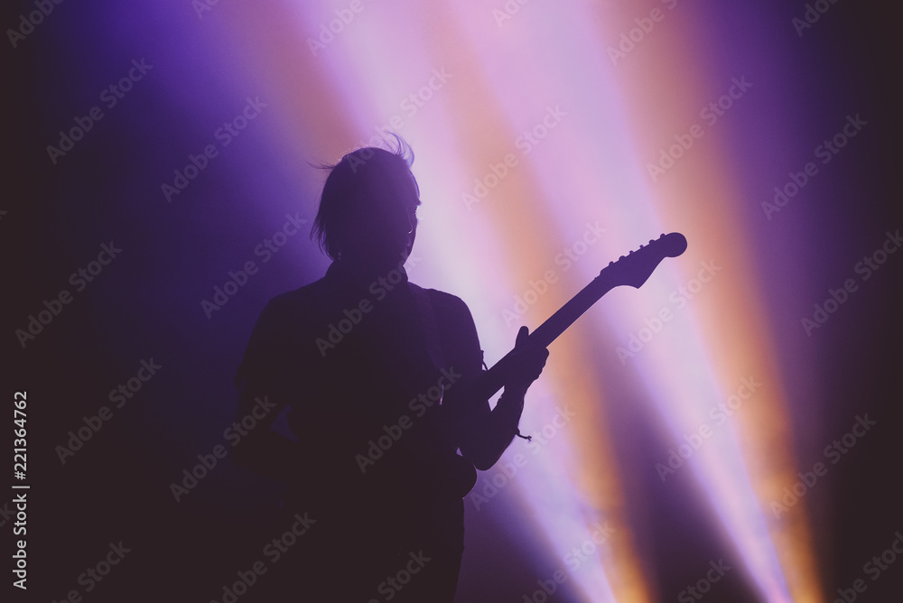 Silhouette of an unrecognizable guitar player